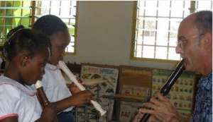 Torrey Stadtner of Stockton teaches children in the Ghanaian village of kibi how to play the recorder.